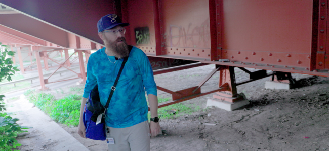 Image Of Social Worker Looking To Help Homeless Under Bridge